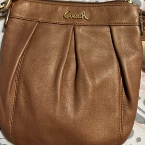Brown coach x body with adjustable strap.